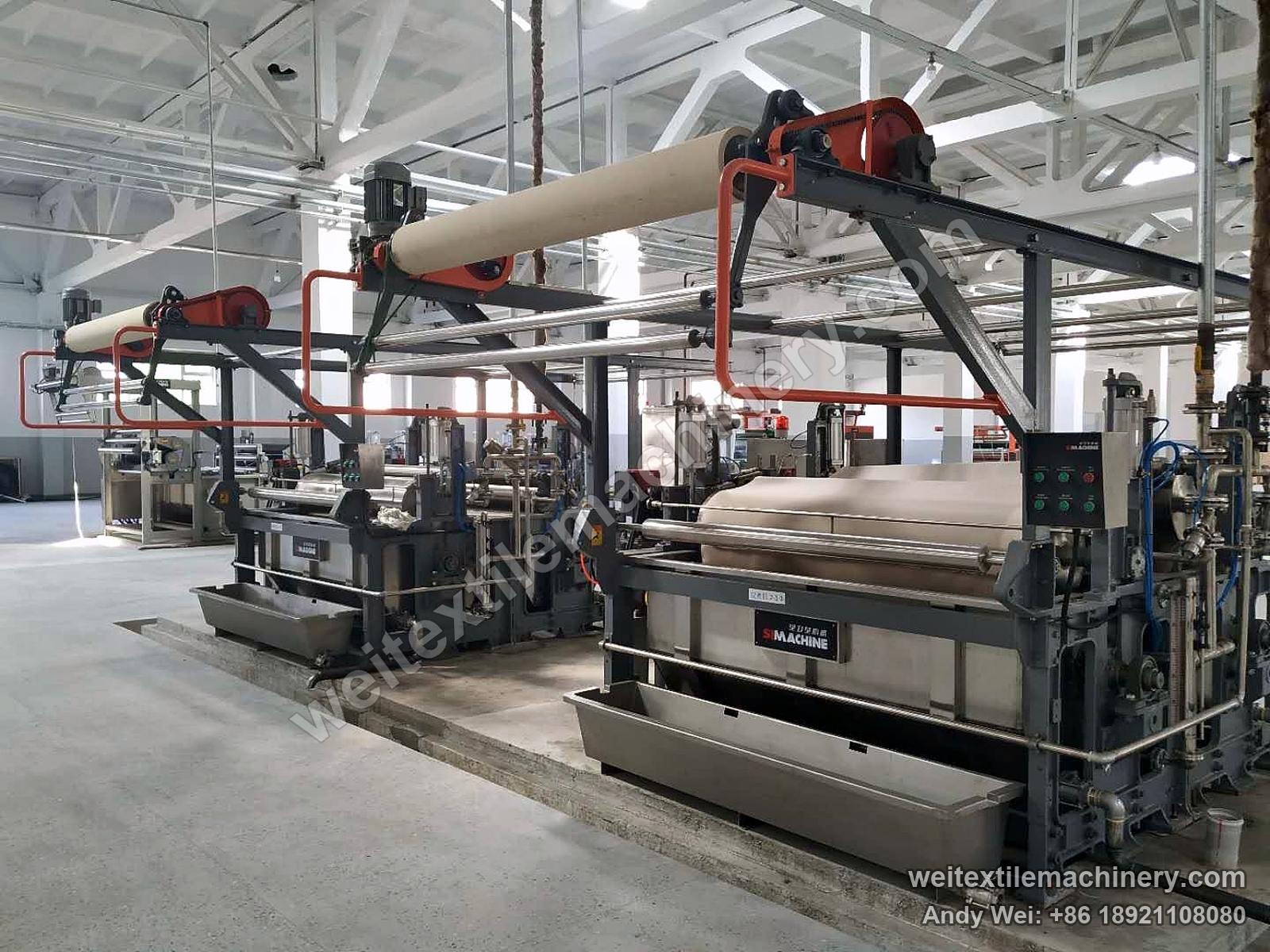 Two earlier-generation QL crabbing machines in line, stainless troughs and cloth rollers