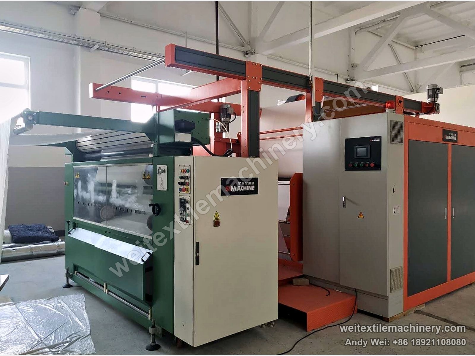 Green QL weft straightener feeding the orange silicone-belt calender