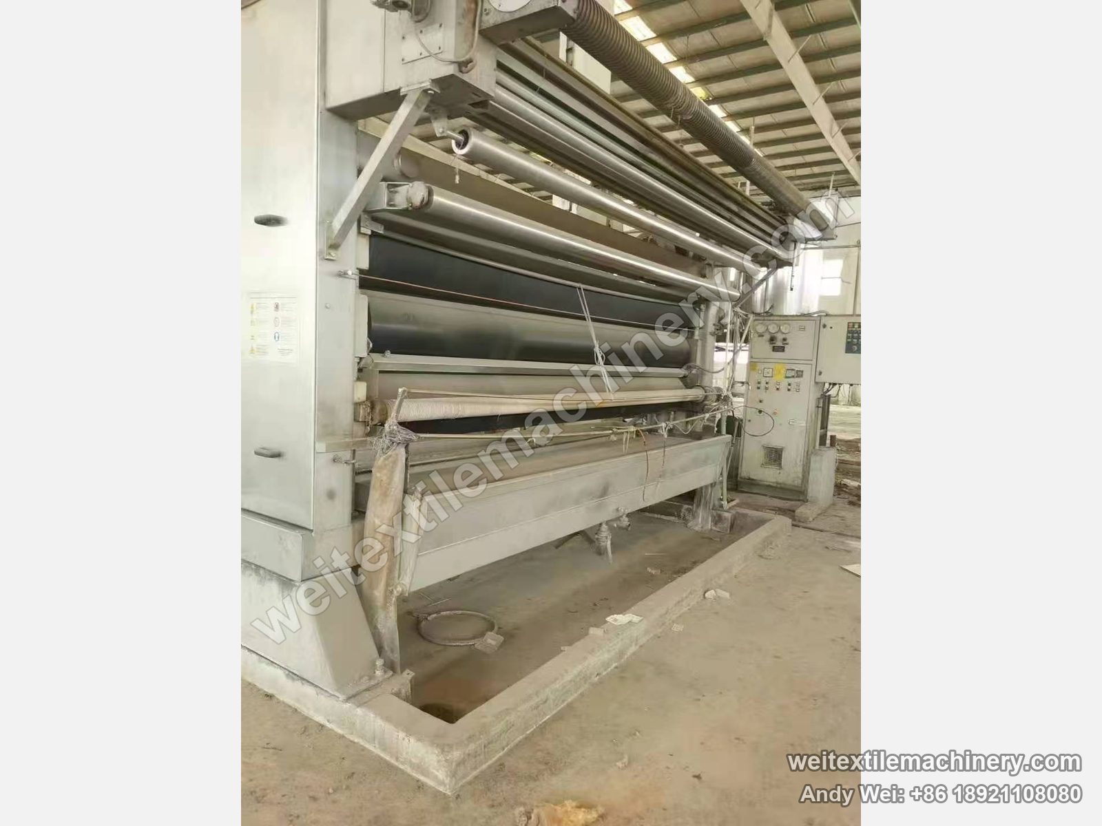 Used Beta FLC-3 squeezing machine, front view with three-roller nip, dancing rollers above and control cabinet with gauges