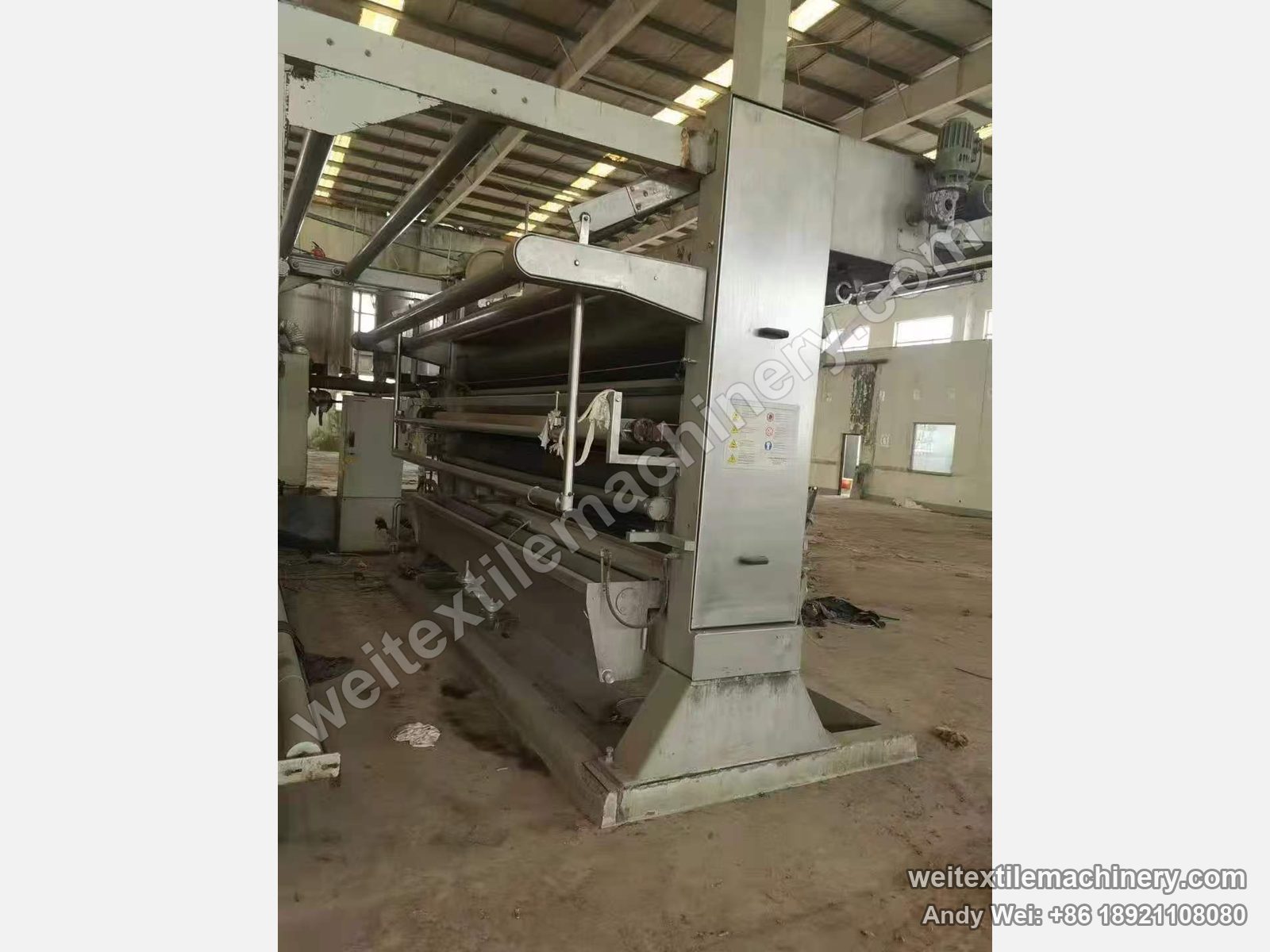 Used Beta FLC-3 squeezing machine, side view with stainless column, top-mounted geared motor and roller stack