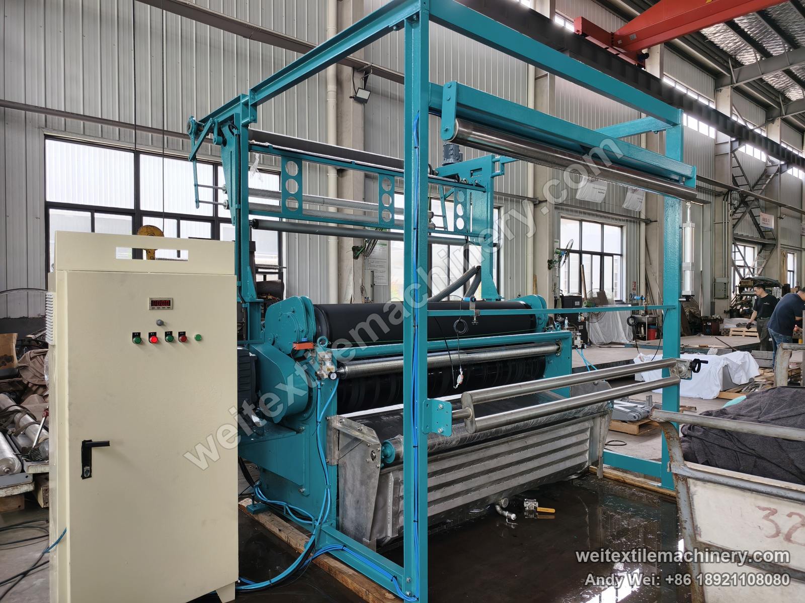 Used Bianco squeezing machine (2.0 m, 2 rolls) after QL rebuild, full view with overhead feed frame, two-roll nip, stainless trough and new control cabinet