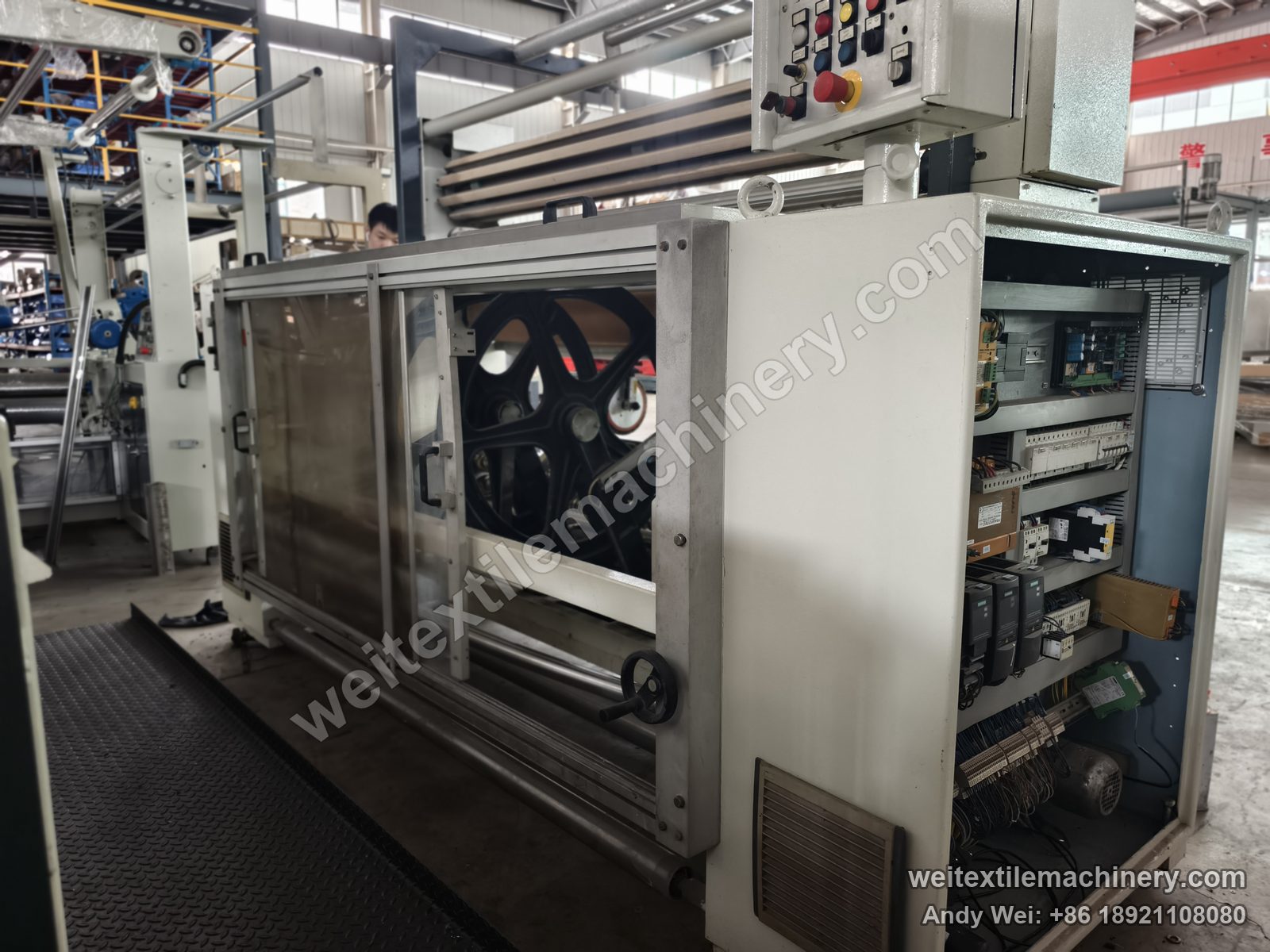 Used Bianco Tramatex SP04 pin-wheel weft straightener, side view with push-button box, open electrical compartment and pin wheel behind the guard