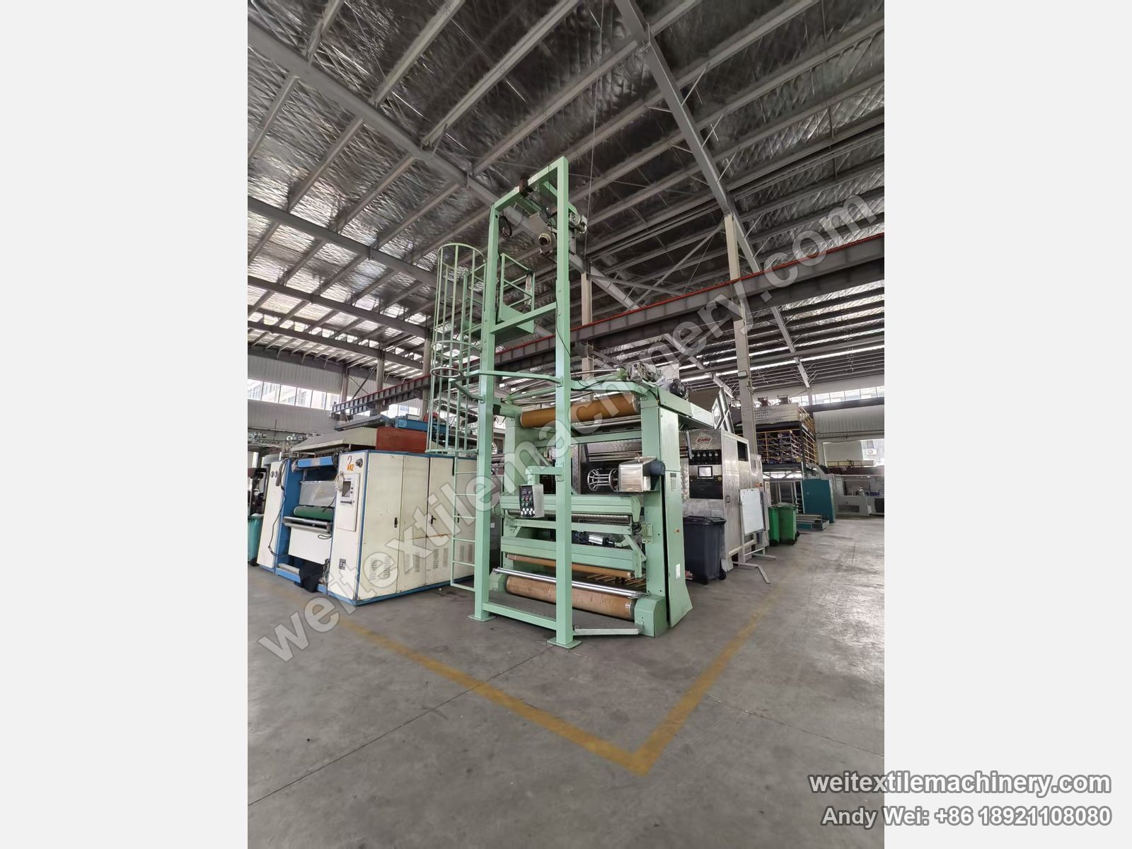 Used Bianco untwisting and opening machine, three-quarter view with caged ladder, detwisting tower and film-wrapped rollers