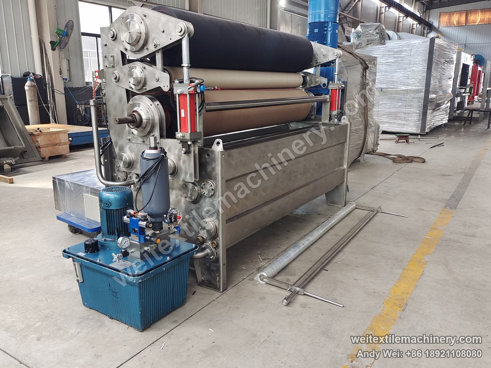 Used CIMI squeezing machine (3 rolls), full view from the hydraulic side with loading cylinders, hydraulic power unit and stainless trough
