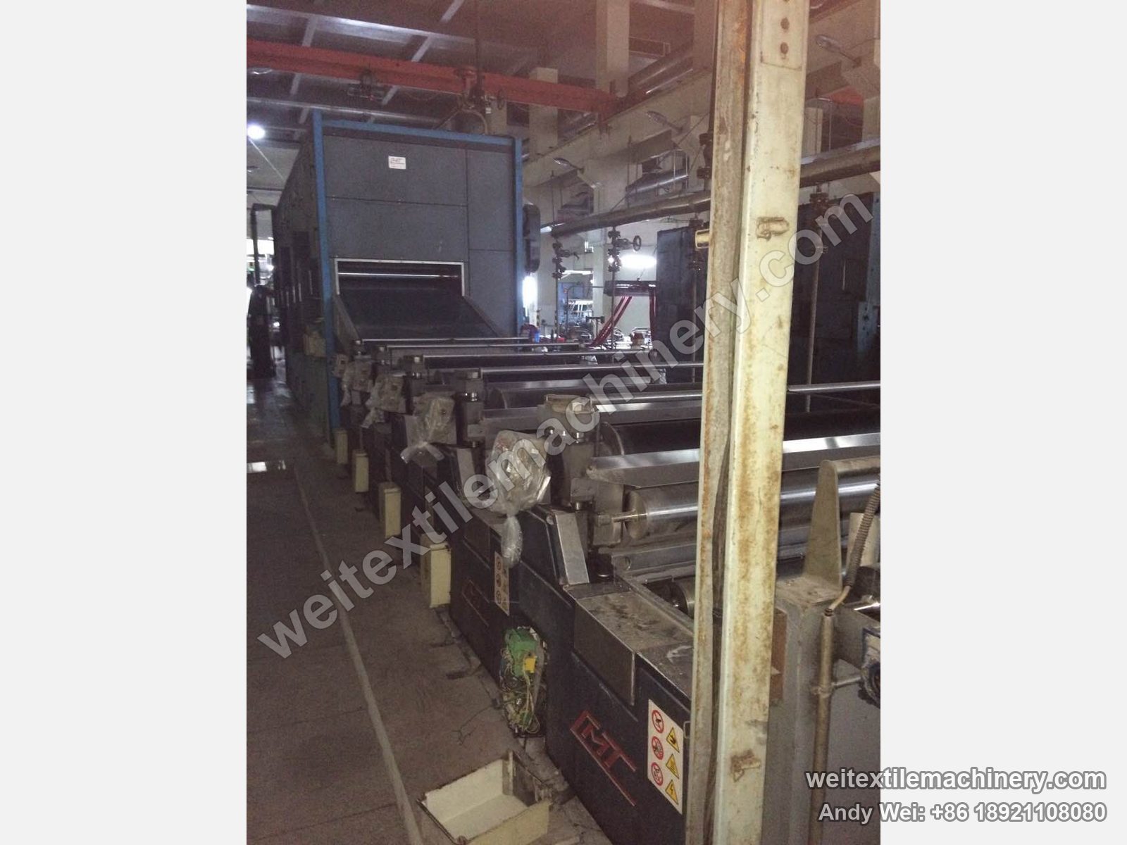Used CMT LTT wool tops backwashing line, washing bowl section with a row of film-wrapped squeeze rolls, CMT logo and dryer section behind