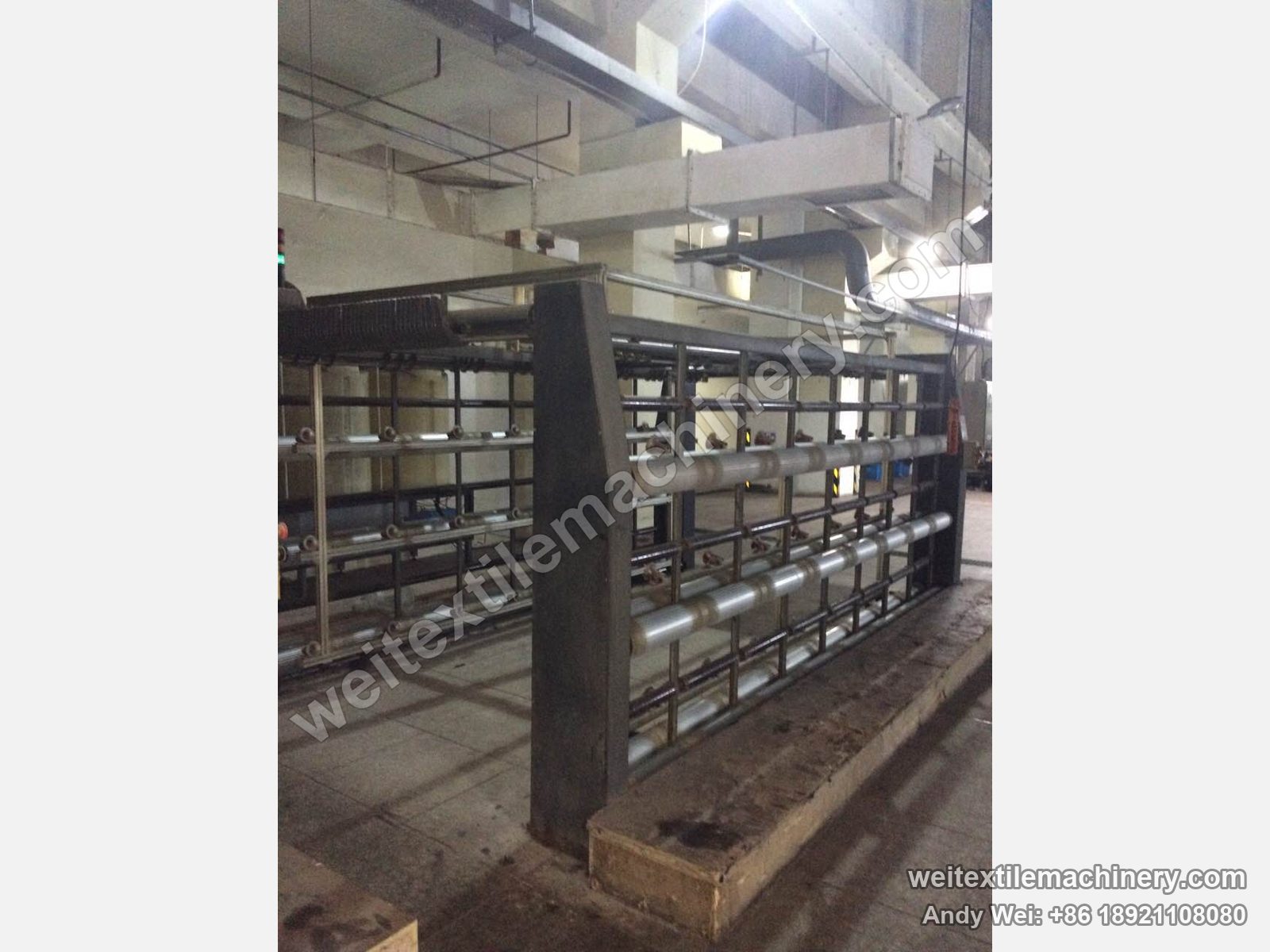 Used CMT tops balling creel, side view with tiers of winding positions and top guide bar