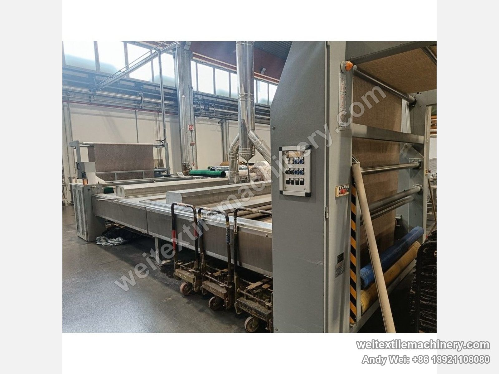 Used CoMaR VAPORAMA belt-type steaming-shrinking machine, one side of the body with button box on the grey column, stainless tank and the belt running along