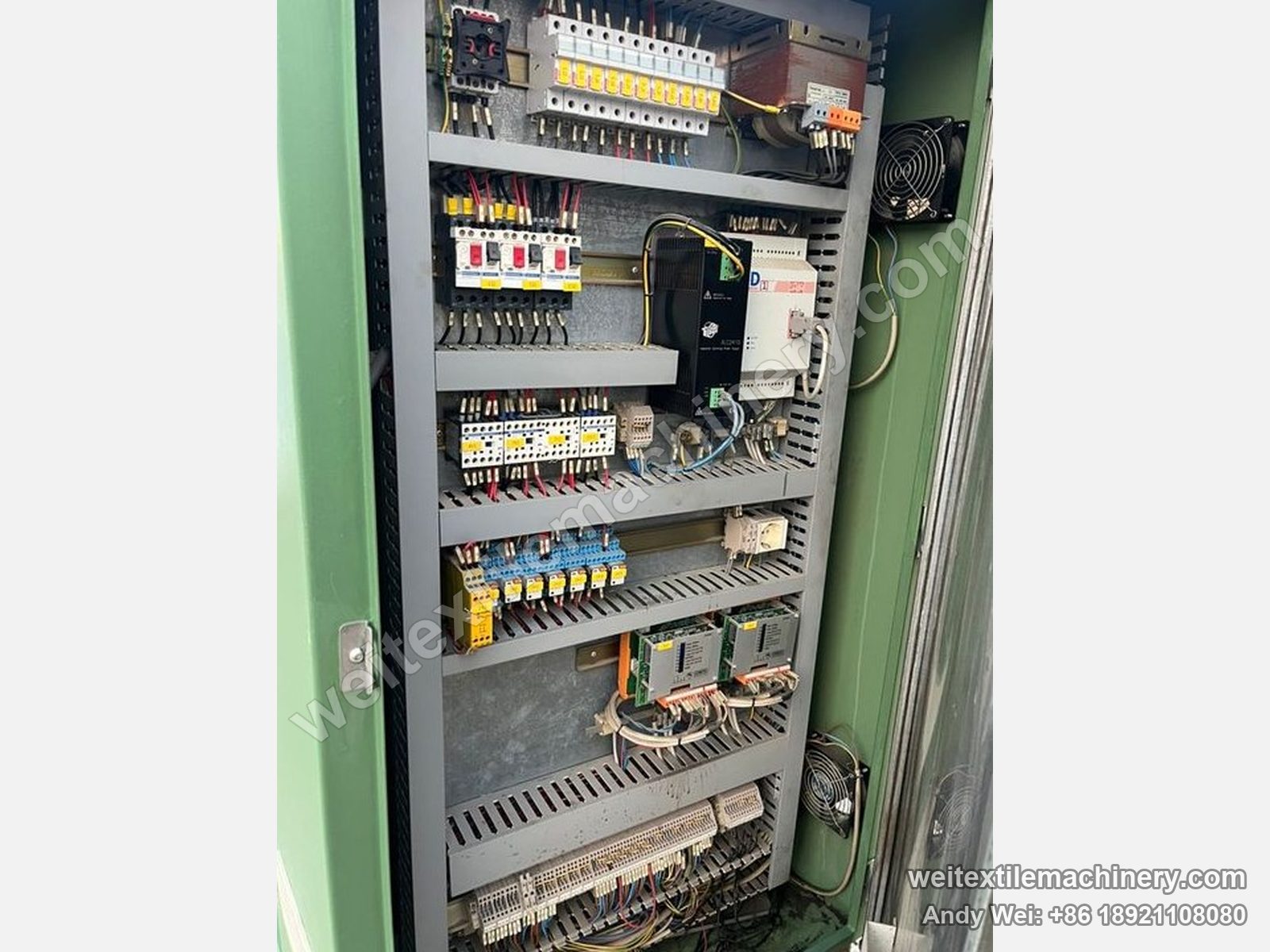 Used Corino photoelectric weft straightener, electrical cabinet with breaker rows, PLC, two servo drives and terminal rows
