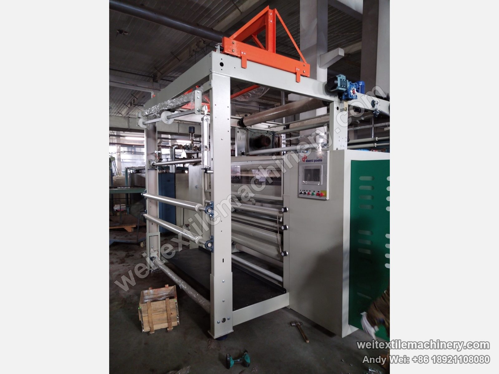 Used Danti Paolo DP7 shearing machine, full view with orange top frame, danti paolo touch-screen panel and film-wrapped rolls