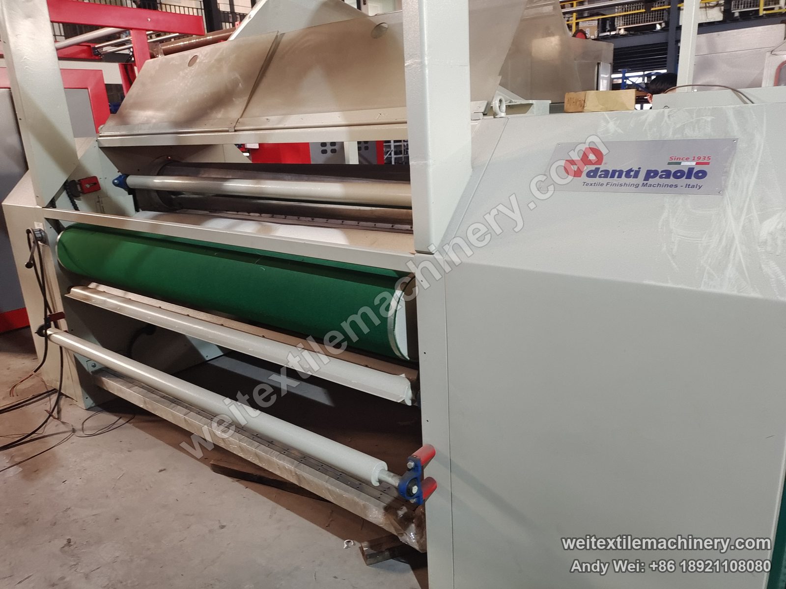 Used Danti Paolo SH8 fabric polishing machine (1.8 m), side close-up with danti paolo plate, green conveyor belt and film-wrapped rolls