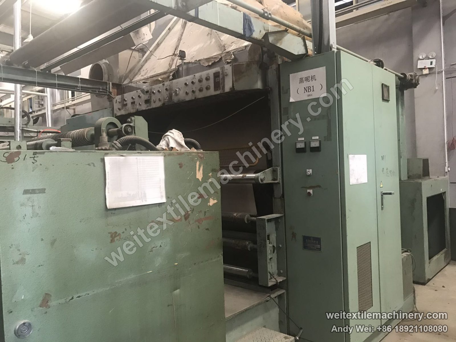 Used Kimura SD 18P OWS semi-decatizing machine, three-quarter view of the green body with open fabric path, rolls, button panel and a paper label on the door