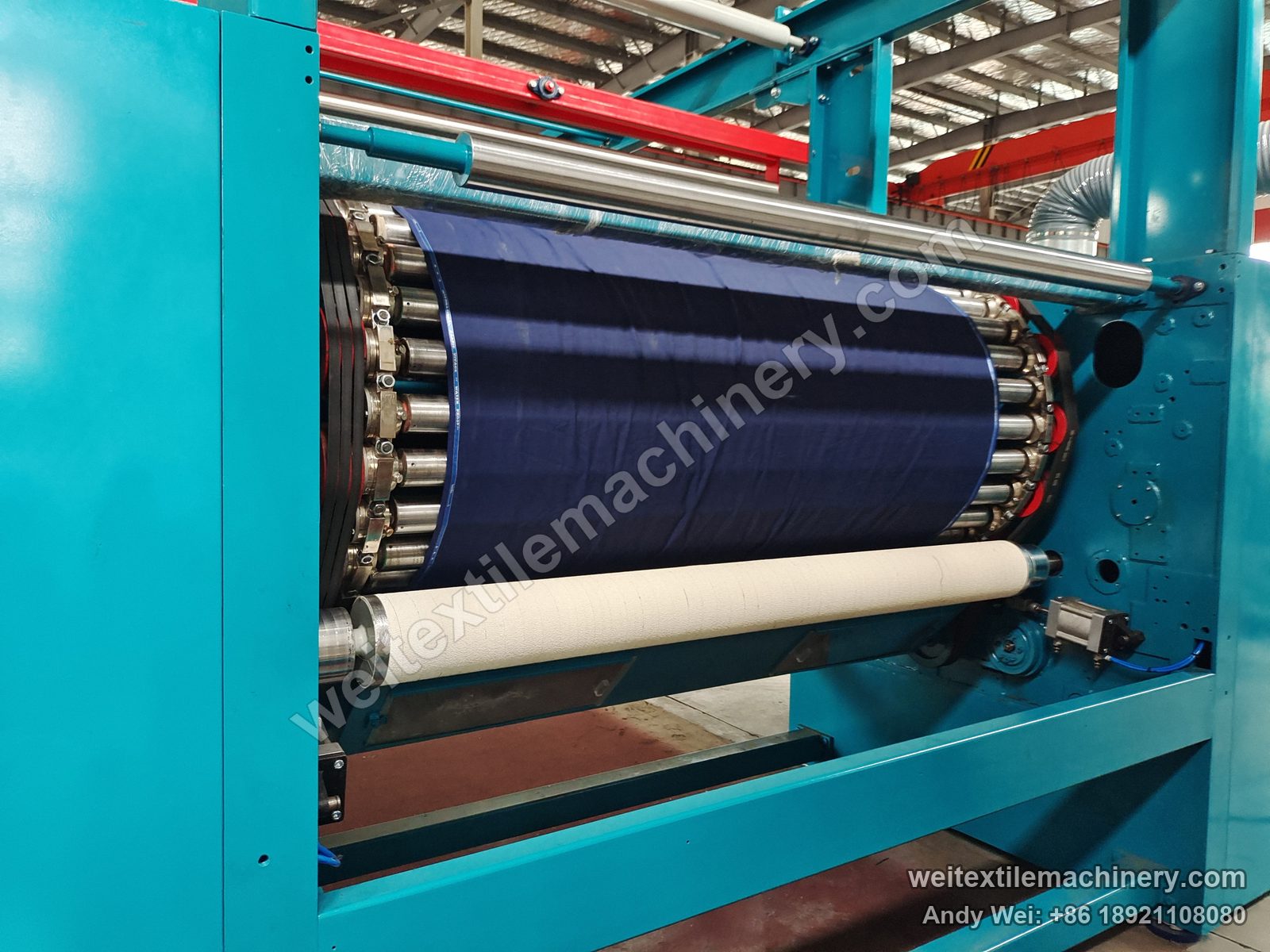Used Lafer GRI 90 raising machine, raising drum close-up with card-wire rollers, fabric and film-wrapped guide roll
