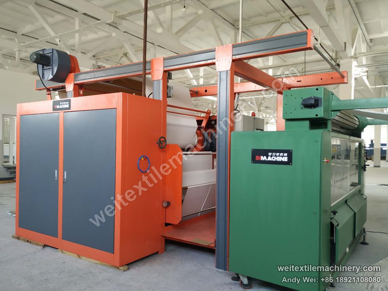 Used M-Tec Contipress 400 silicone-belt calender, another angle with green feed unit and orange calender body