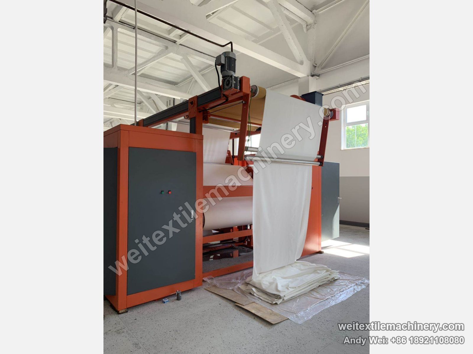 Used M-Tec Contipress 400 silicone-belt calender, entry end with fabric feed, top motor and orange frame