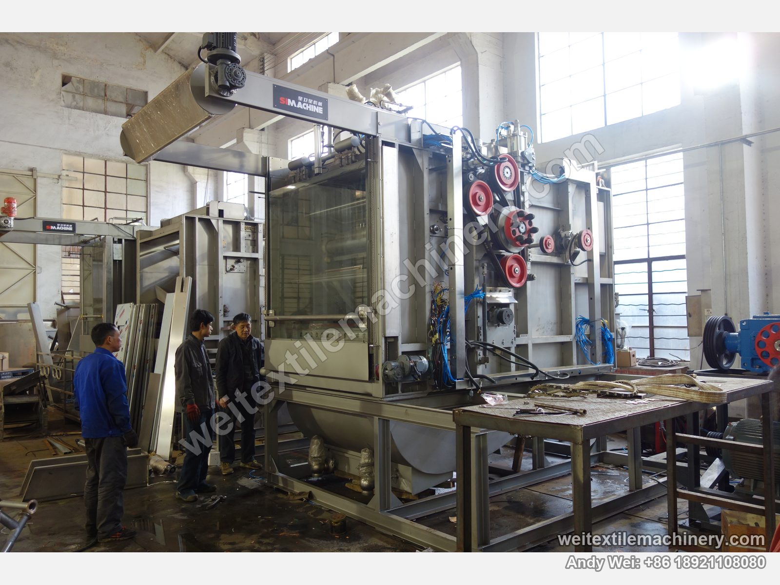 Used MAT Turbomat 2C rope scouring and milling machine, wider three-quarter view with glass door, red pulleys, lead screw, stainless tank and platform