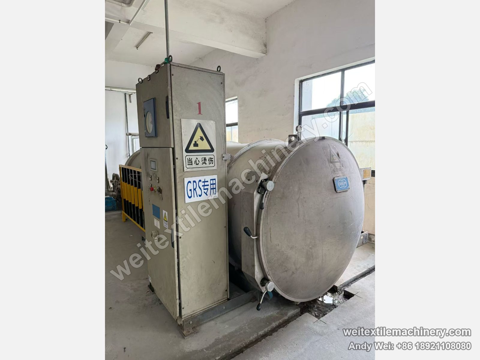 Used Obem VFPV vacuum yarn steaming autoclave, full view with stainless vessel, round door with OBEM badge, control cabinet with gauge and touch screen