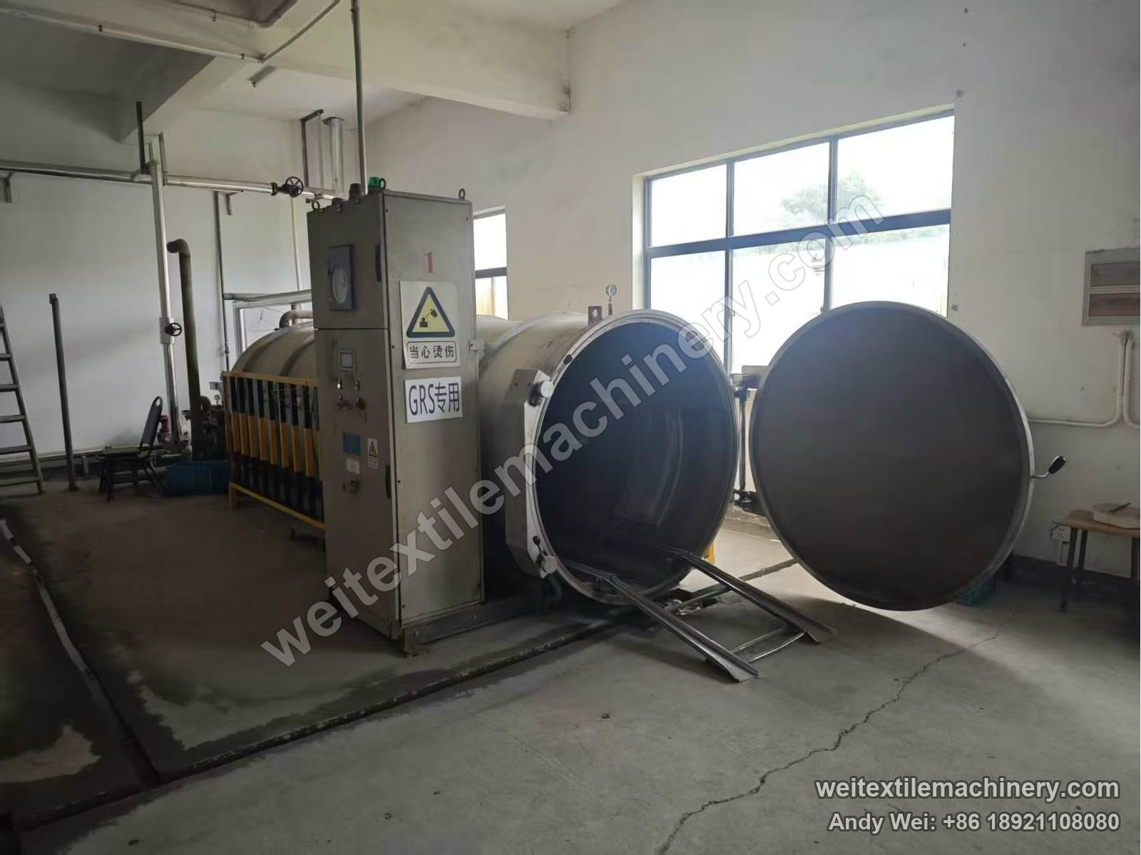 Used Obem VFPV vacuum yarn steaming autoclave with door open, internal rails and entry rails, control cabinet and yellow-black guard at left