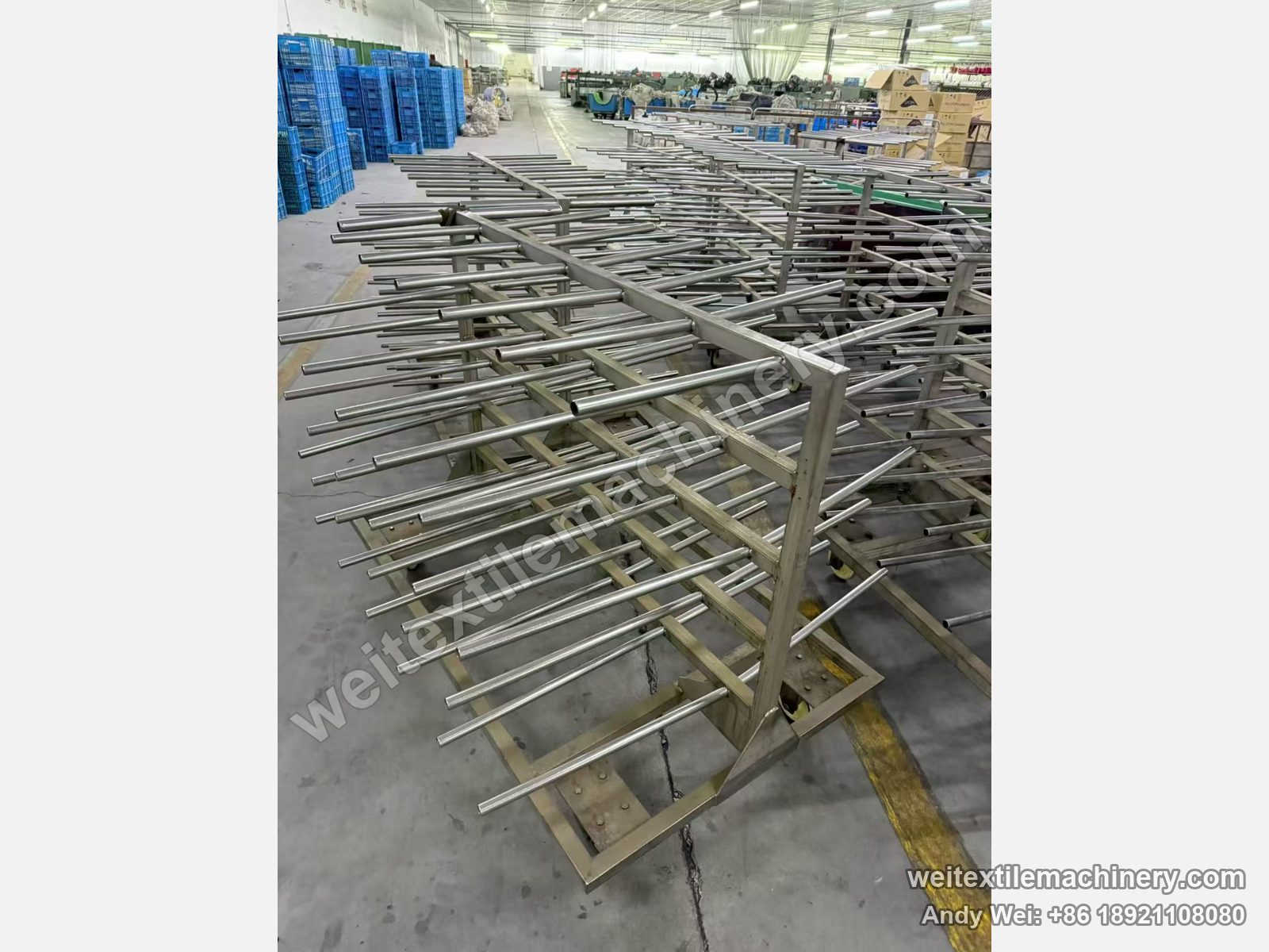 Used Obem VFPV vacuum yarn steaming autoclave, empty stainless spindle trolleys lined up in the mill