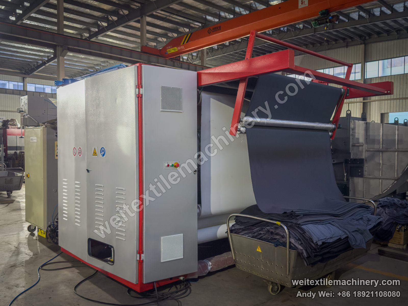 Used Sperotto Rimar Multidecat 2.0 continuous decatizing machine, rear view with red frame, silver doors, overhead fabric frame and stainless trolley