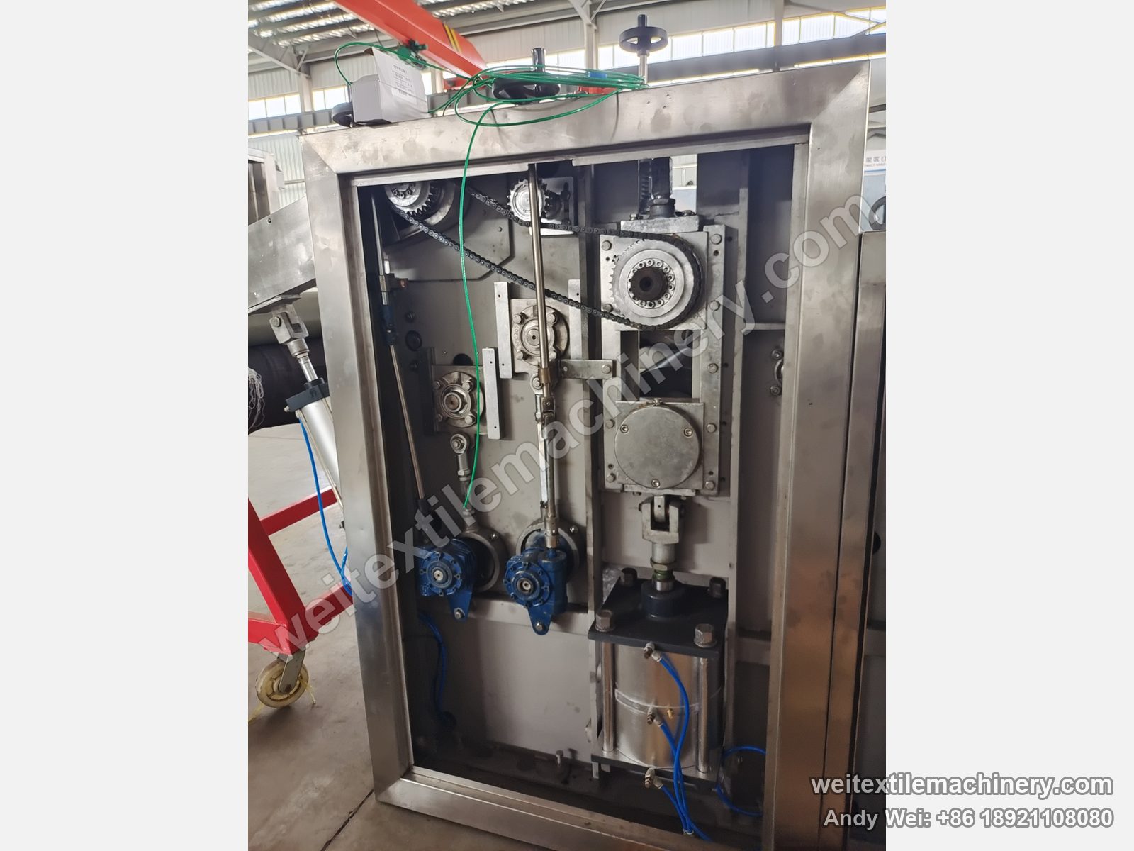 Used TMT STC 4D+4R wet brushing and setting machine, drive compartment with chain sprockets, two blue geared motors and pneumatic cylinder