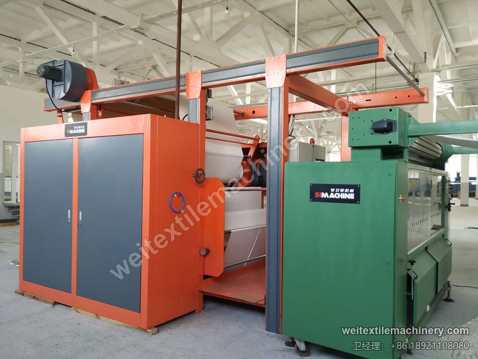 二手 M-Tec Contipress 400 硅胶导带压光机另一角度，绿色进布单元与橙色压光主机