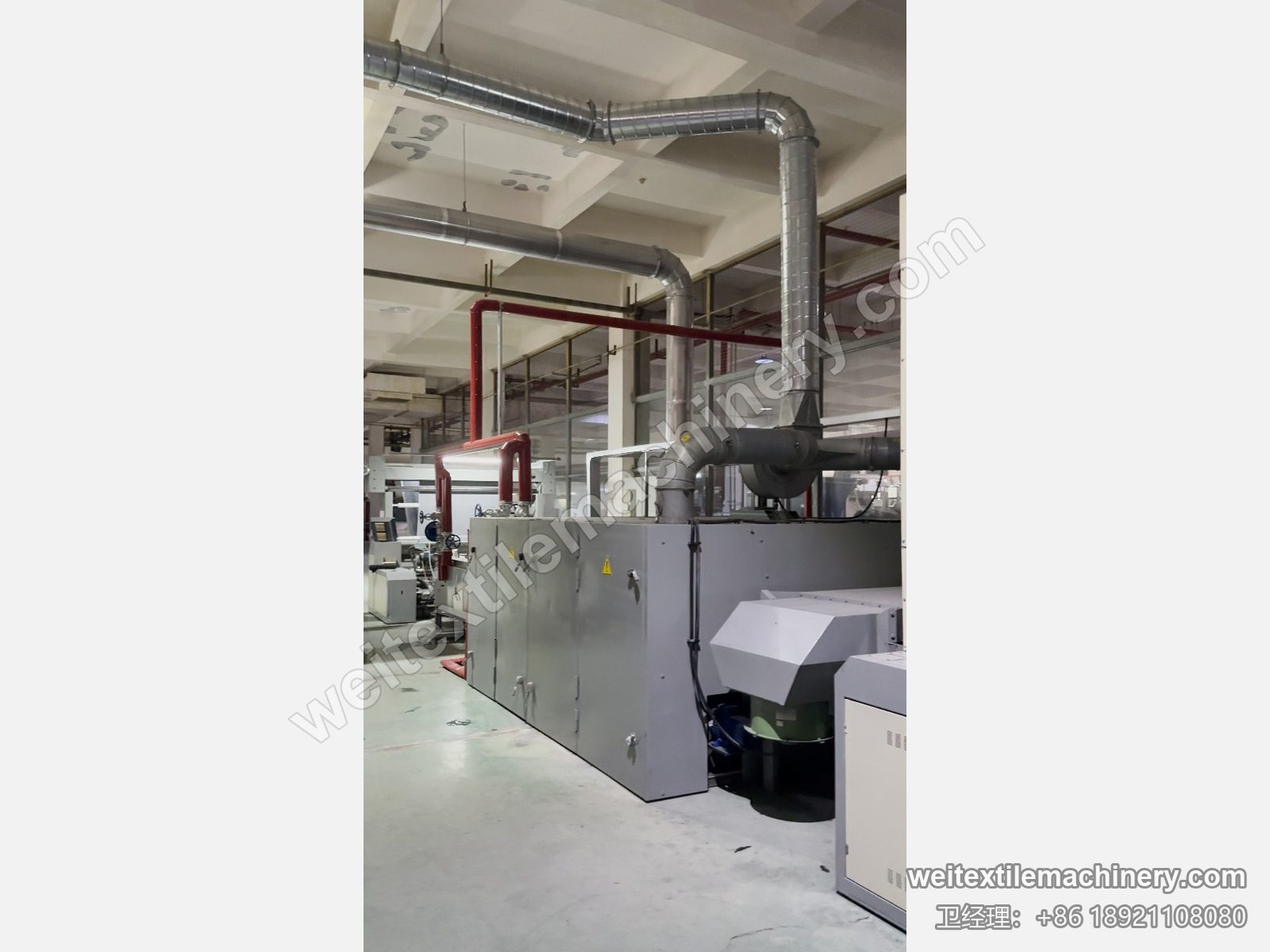 二手 Unitech F2 链条式汽蒸预缩机侧面，灰色箱体、排气管道与鼓风机罩