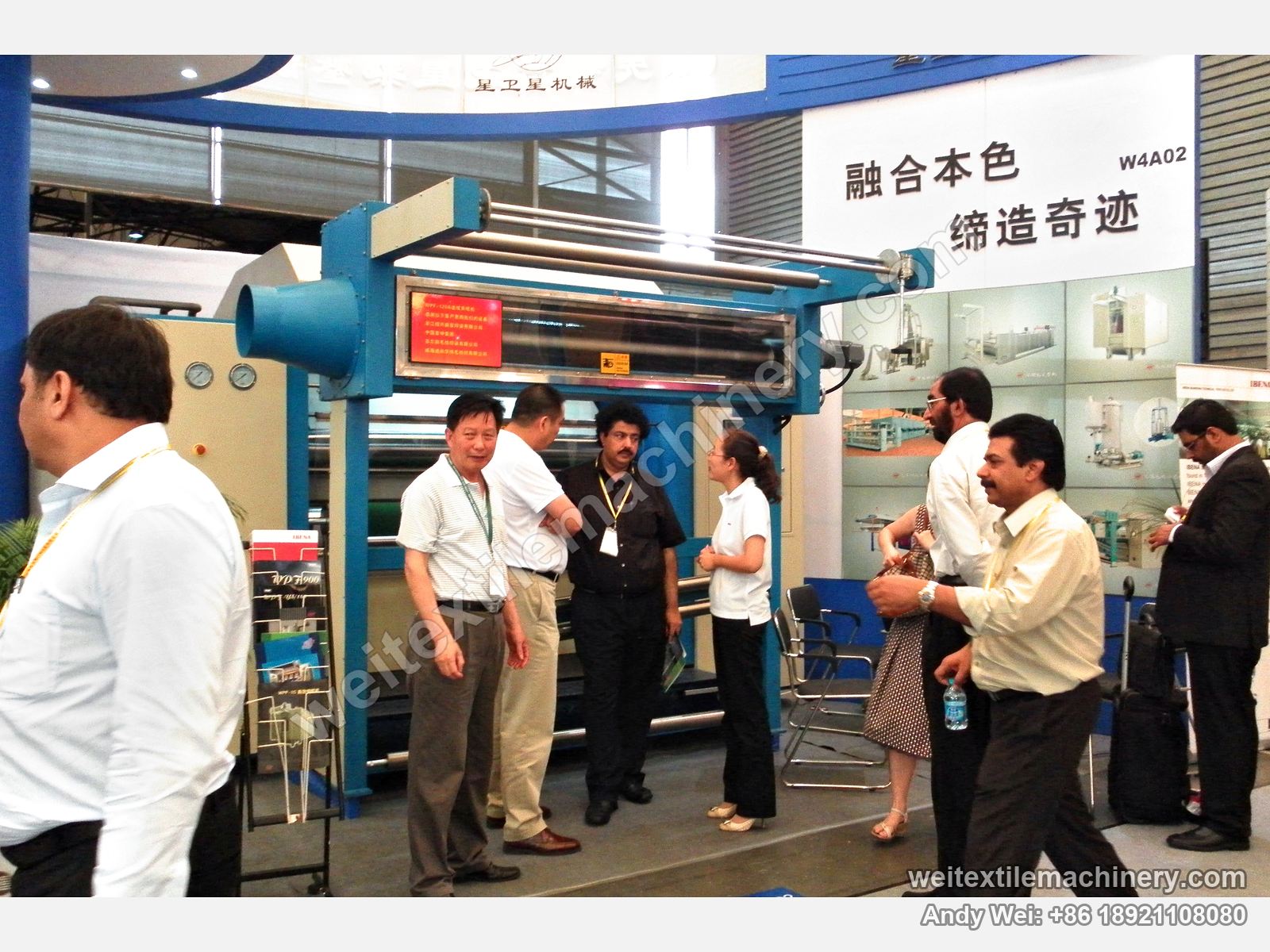 Visitors talking beside the WPF-120 continuous decatizing machine on the 2010 stand
