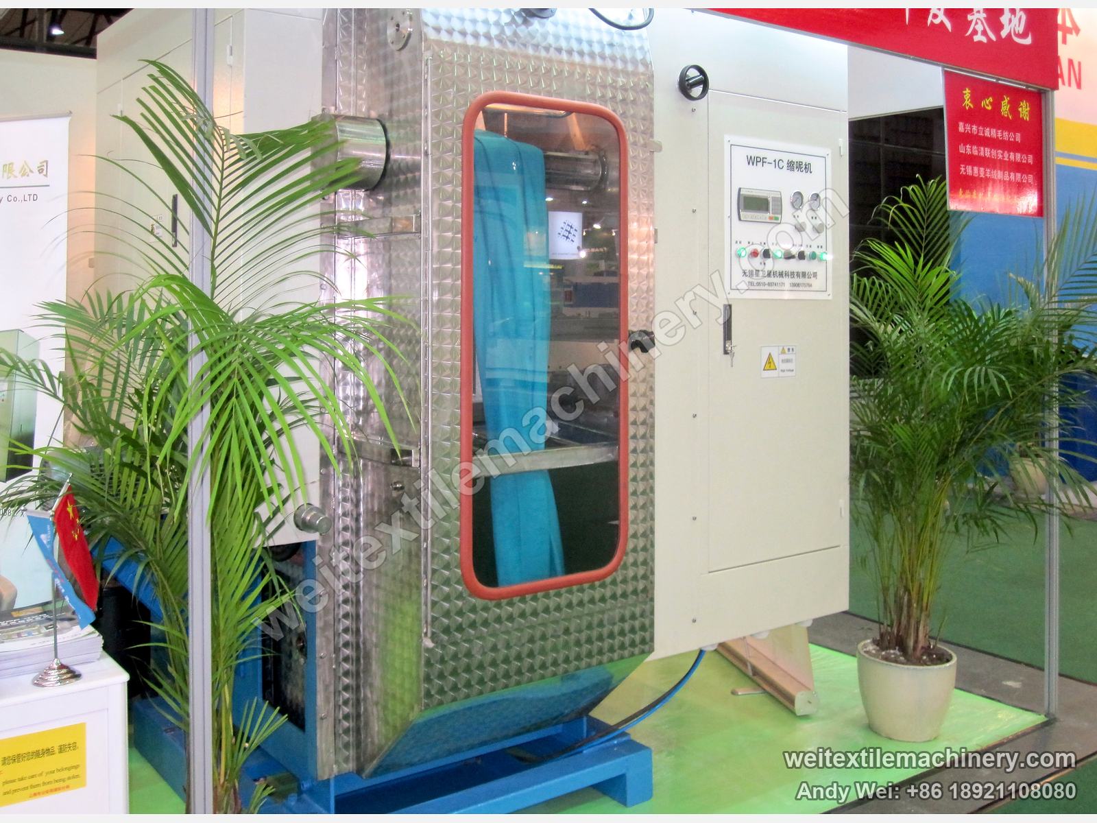 The WPF-1C milling machine on the 2011 stand, blue fabric behind the viewing window