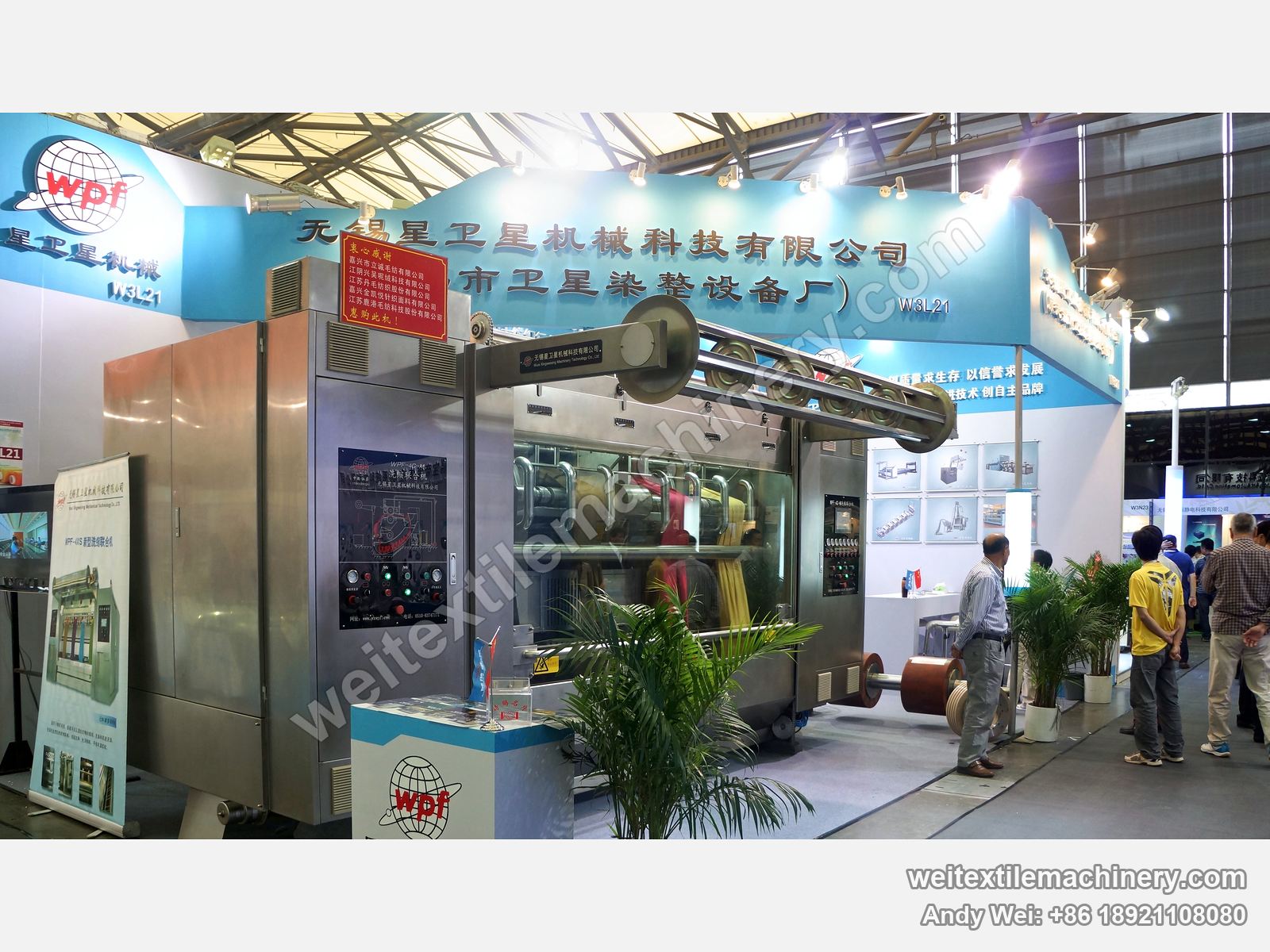 The WPF-4C-M scouring and milling machine on the 2013 stand, with wooden milling rollers beside it