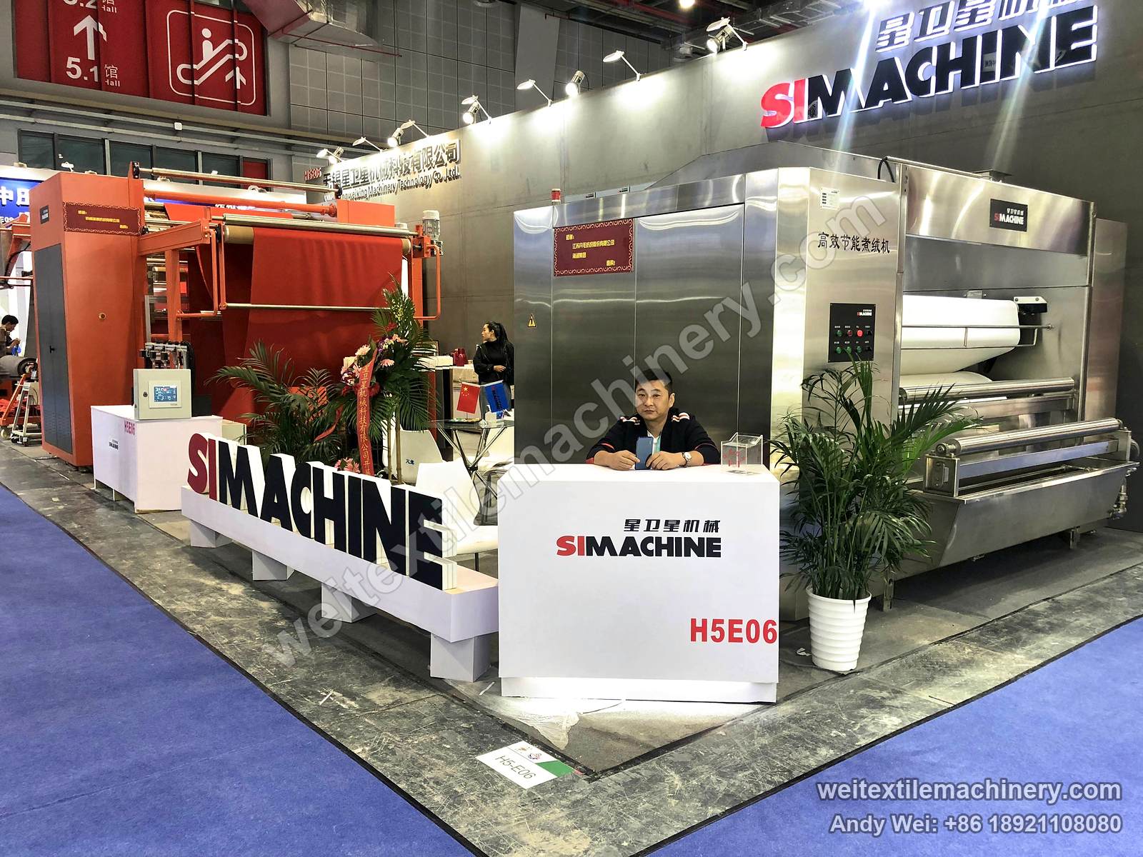 The 2018 SIMACHINE stand: an orange teasel raising machine on the left and a stainless-steel machine on the right